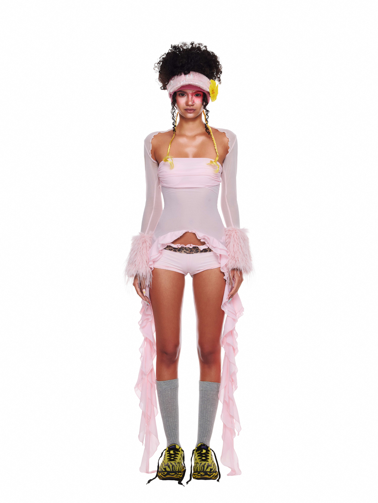 Model wearing Lolli Set with long ruffle sleeves and layered sheer beachwear in soft pink