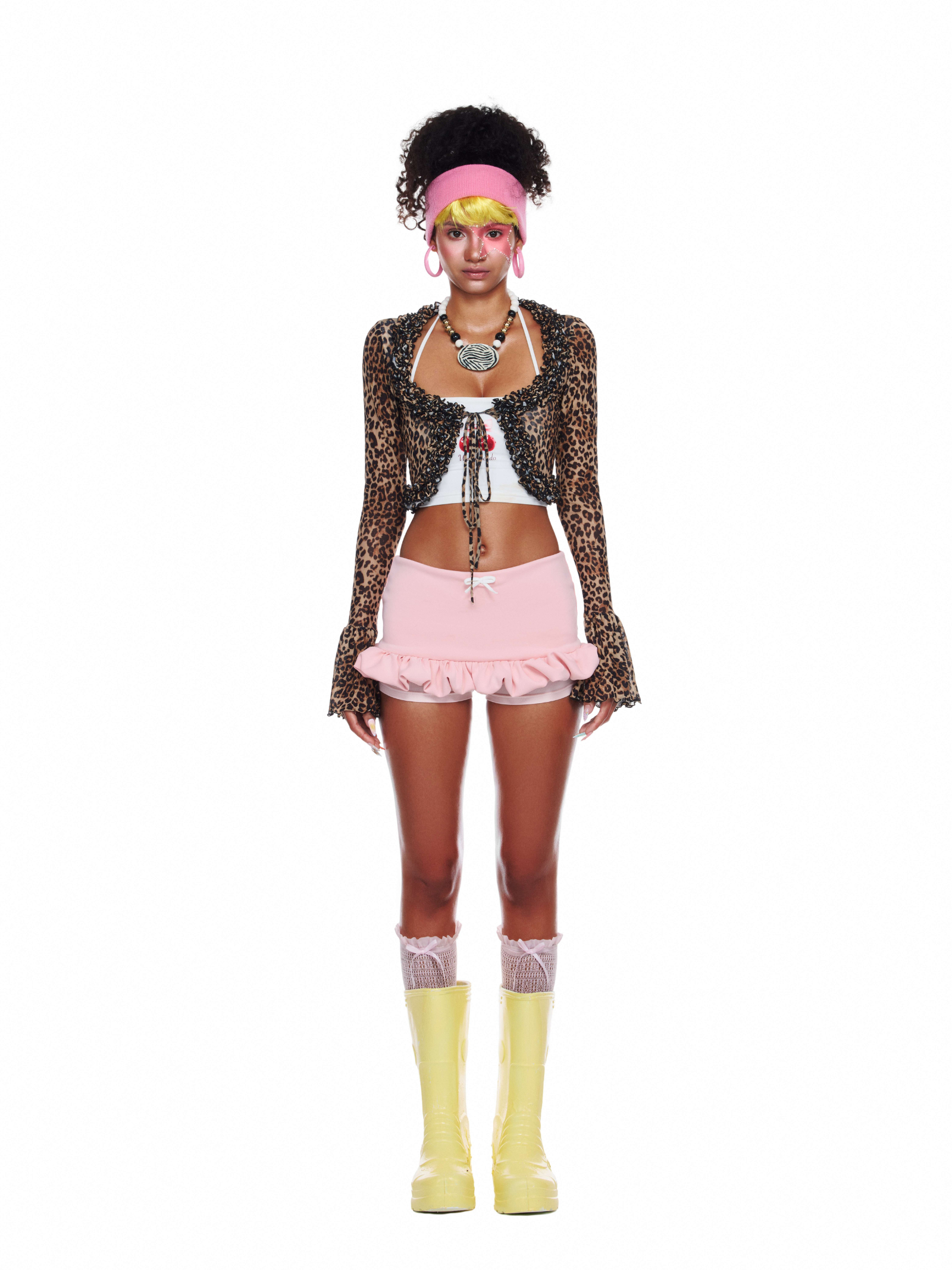 Model wearing the Aurora Set featuring leopard mesh shrug, white halter bralette, and pink ruffle skirt – bold and playful beach clothes look.
