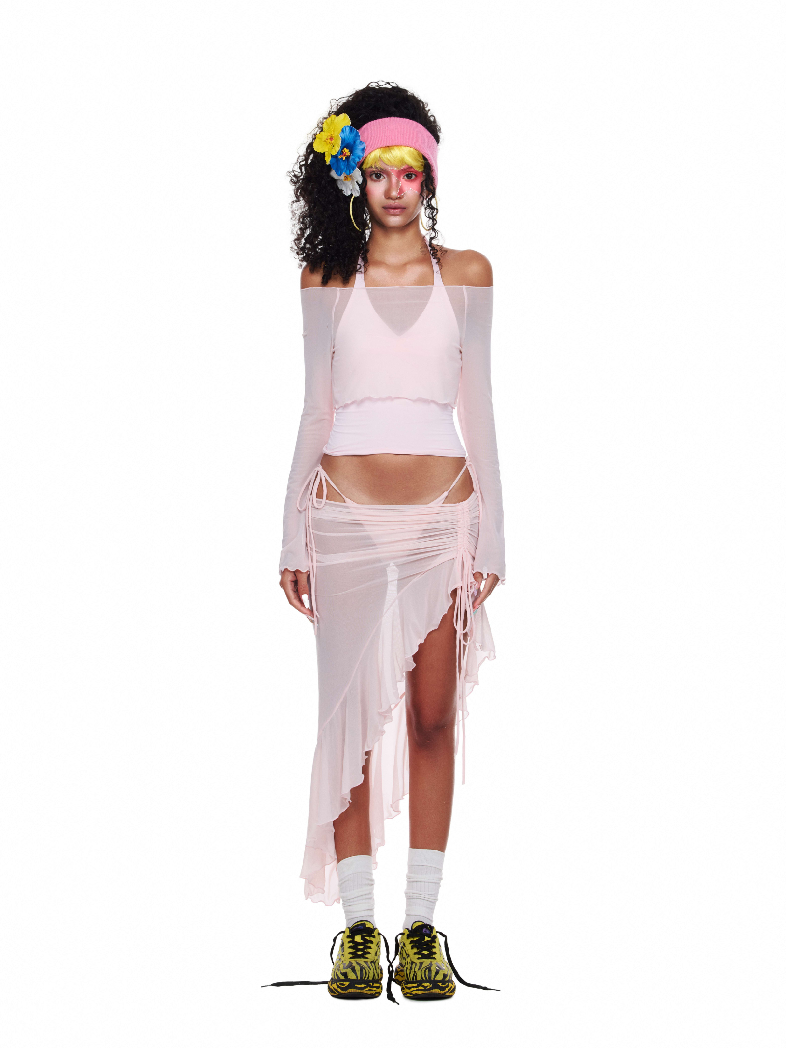 Model wearing a pink 4-piece beach party outfit with halter bikini top, sheer off-shoulder cover-up, ruffled mesh skirt, and matching bikini bottoms.