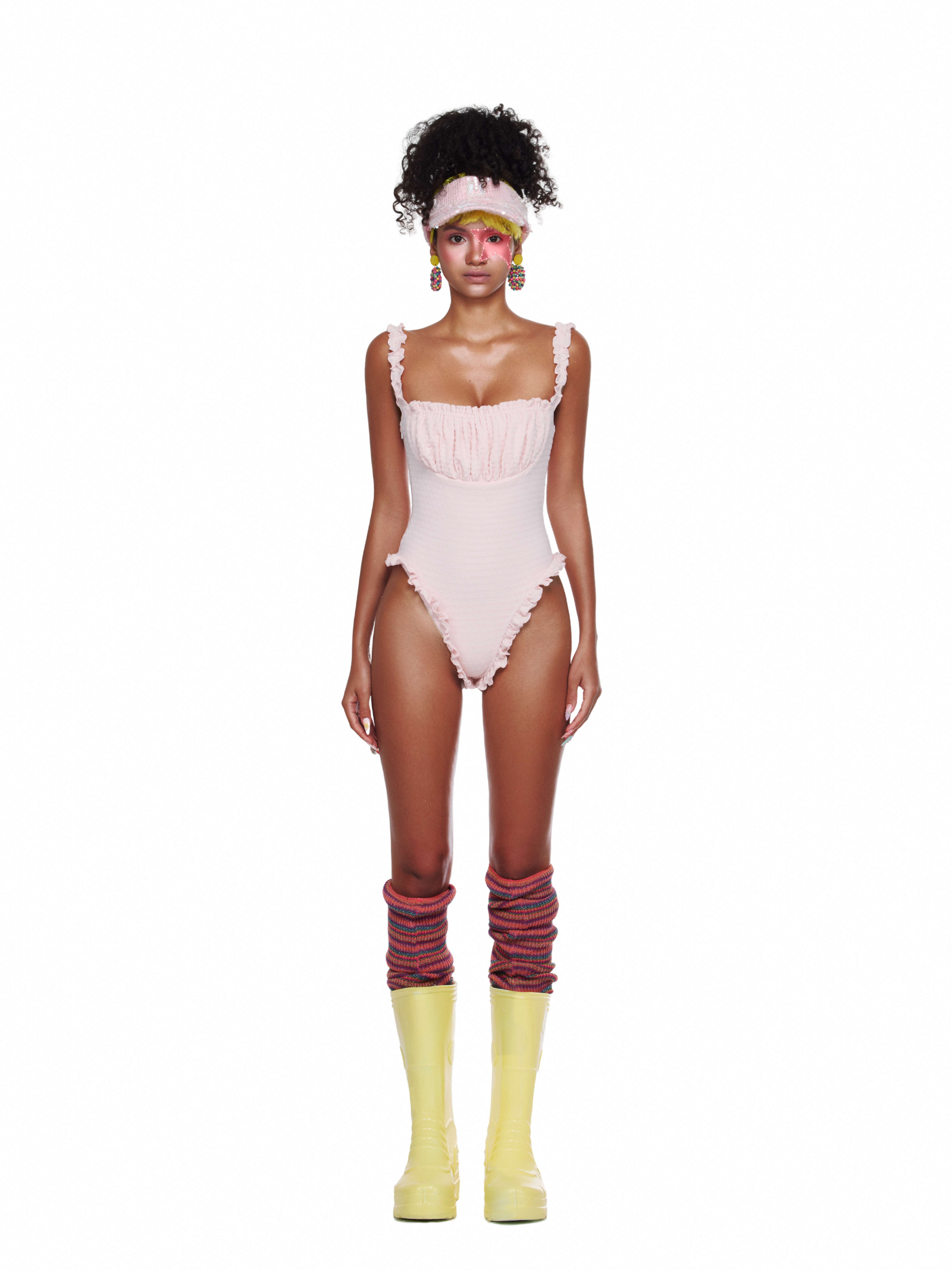 Pastel pink Twirl Bodysuit with ruffles — an elegant choice in beachwear swimsuits.