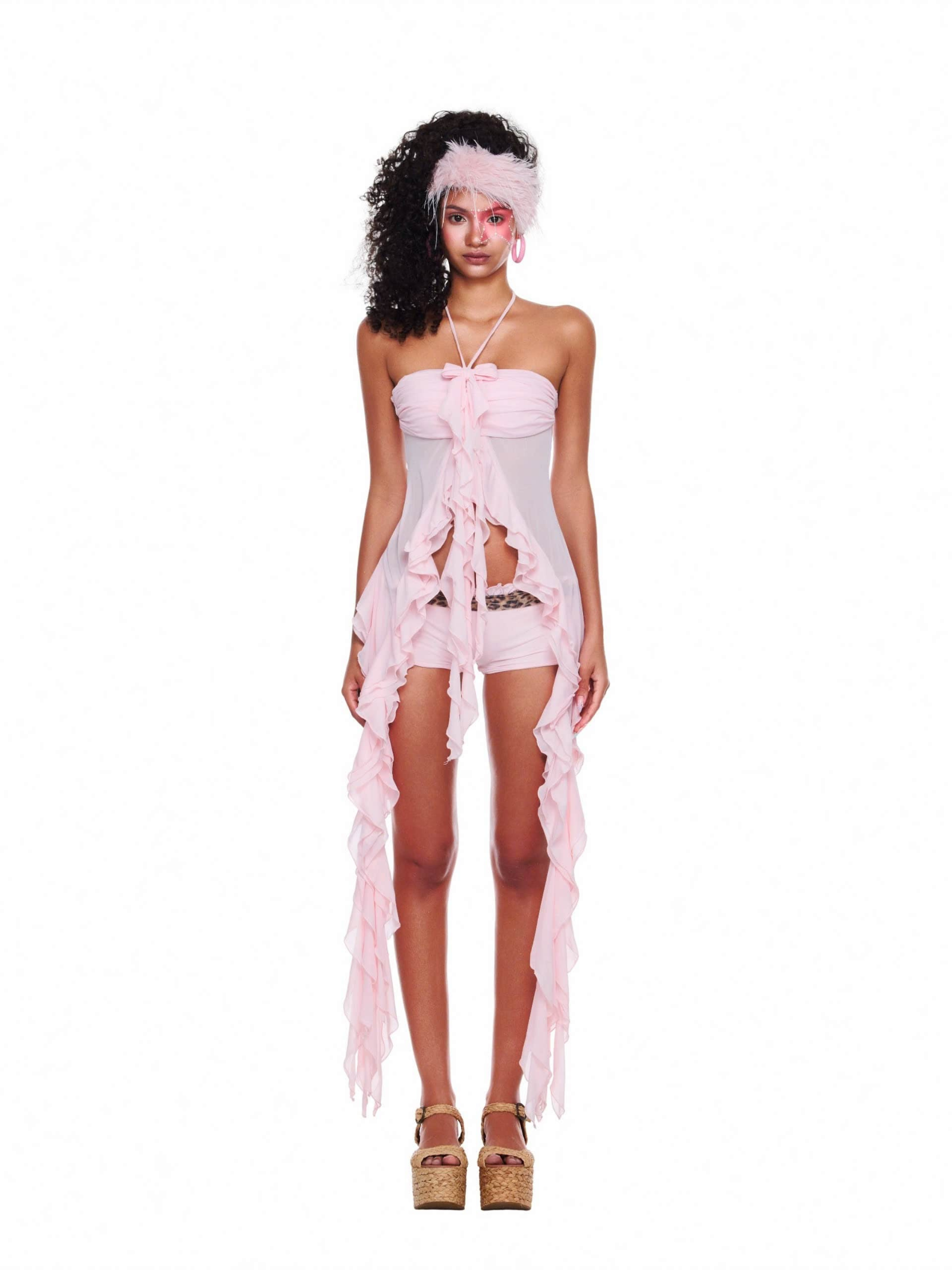 Model wearing the Seashell Halter Top in soft pink chiffon — a romantic beach outfit featuring ruffle details, tie-neck halter, and flowing slit hem perfect for summer.